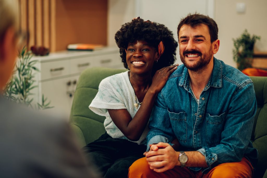 Alcohol dependent couple sitting and smiling after completing Journey to Recovery