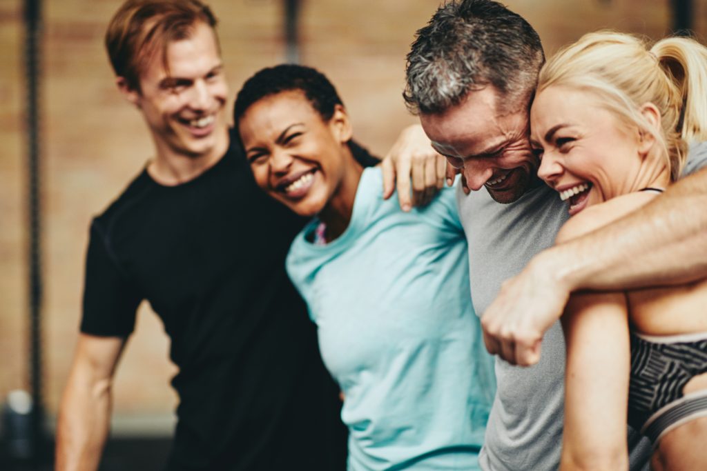 A diverse group of people laughing and smiling together Overcoming Alcohol Addiction.