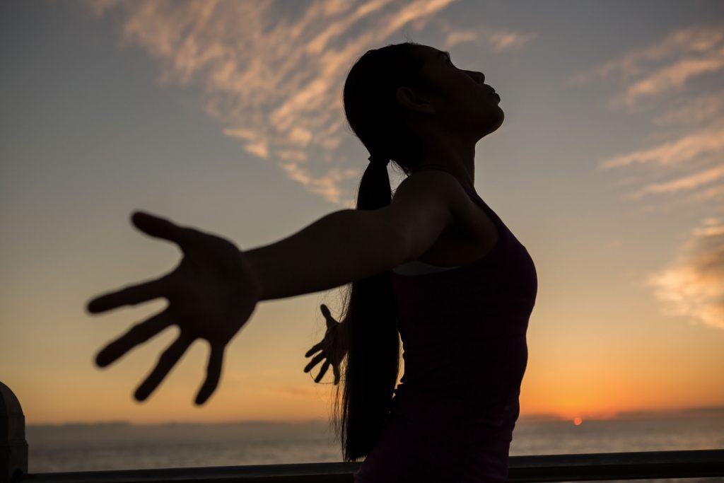 Carefree woman with arms stretched.