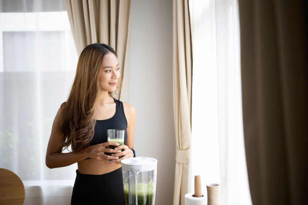 Beautiful young woman drinking healthy smoothie.