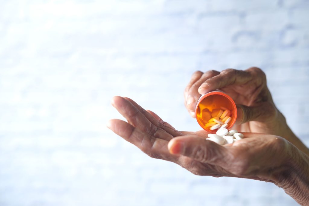 Woman taking medicine.