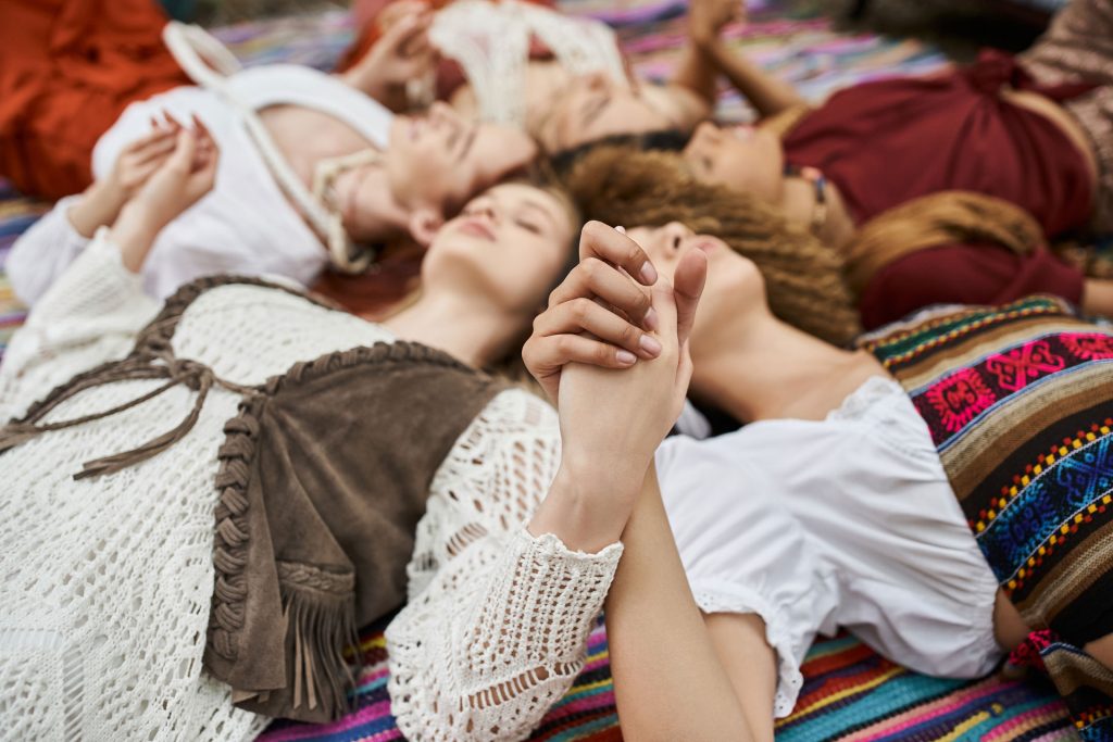 Woman holding hands while lying.