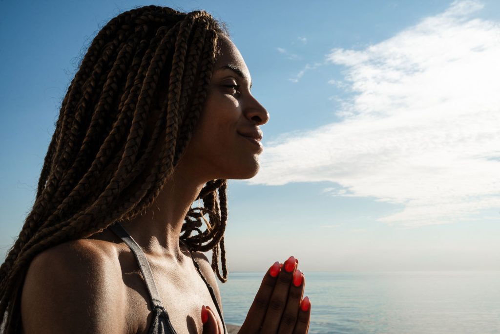 Beautiful woman meditating after life of addiction.