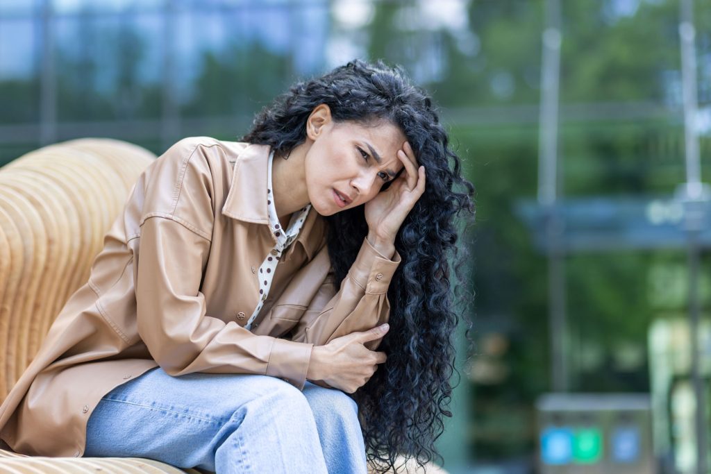 Woman with depression having a headache.