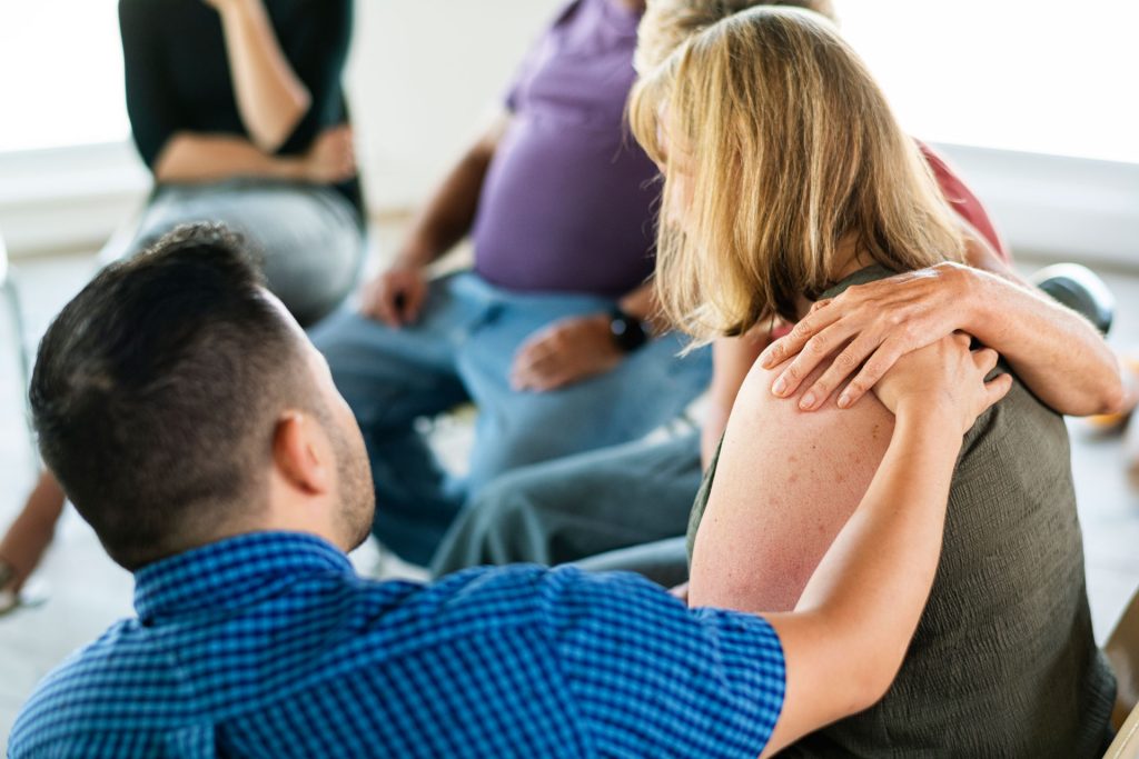 Man consoling friend with mood disorder.