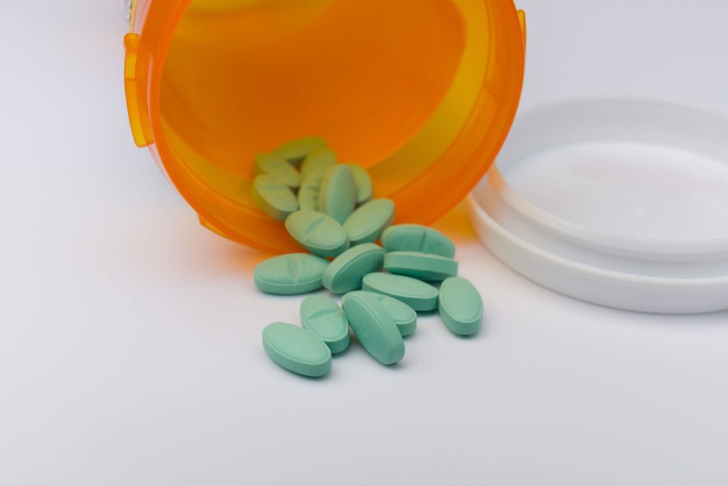 Pills spilling out of a pill bottle.