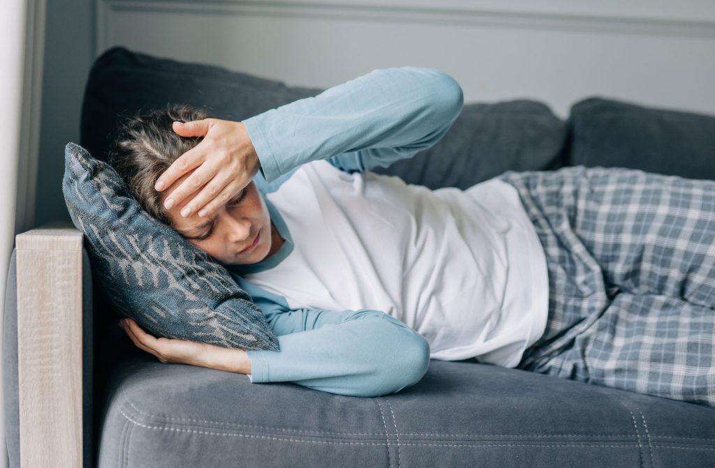 A sick woman in sofa.