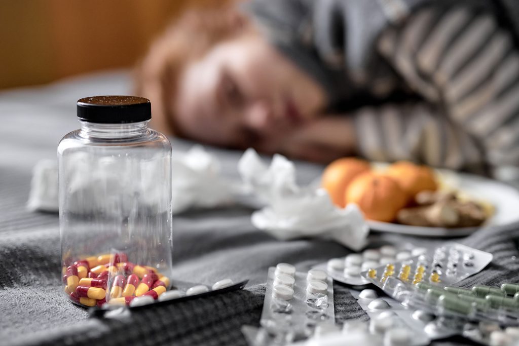 Focused on bottle of pills.