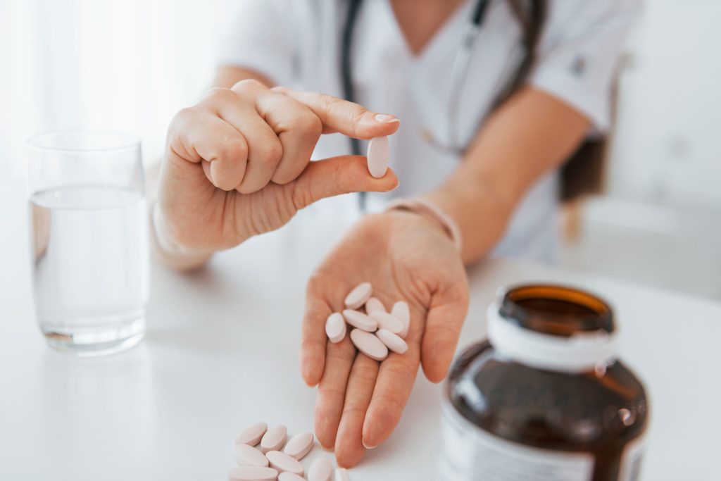 Pills on the hand of a professional medical worker.