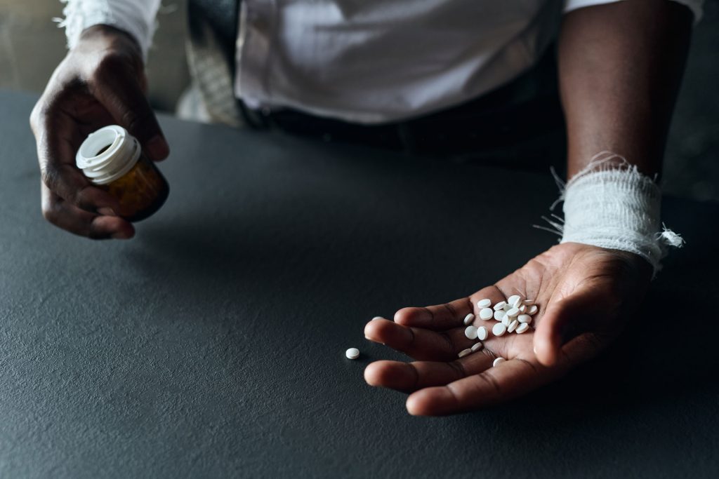 Man in depression taking pills.