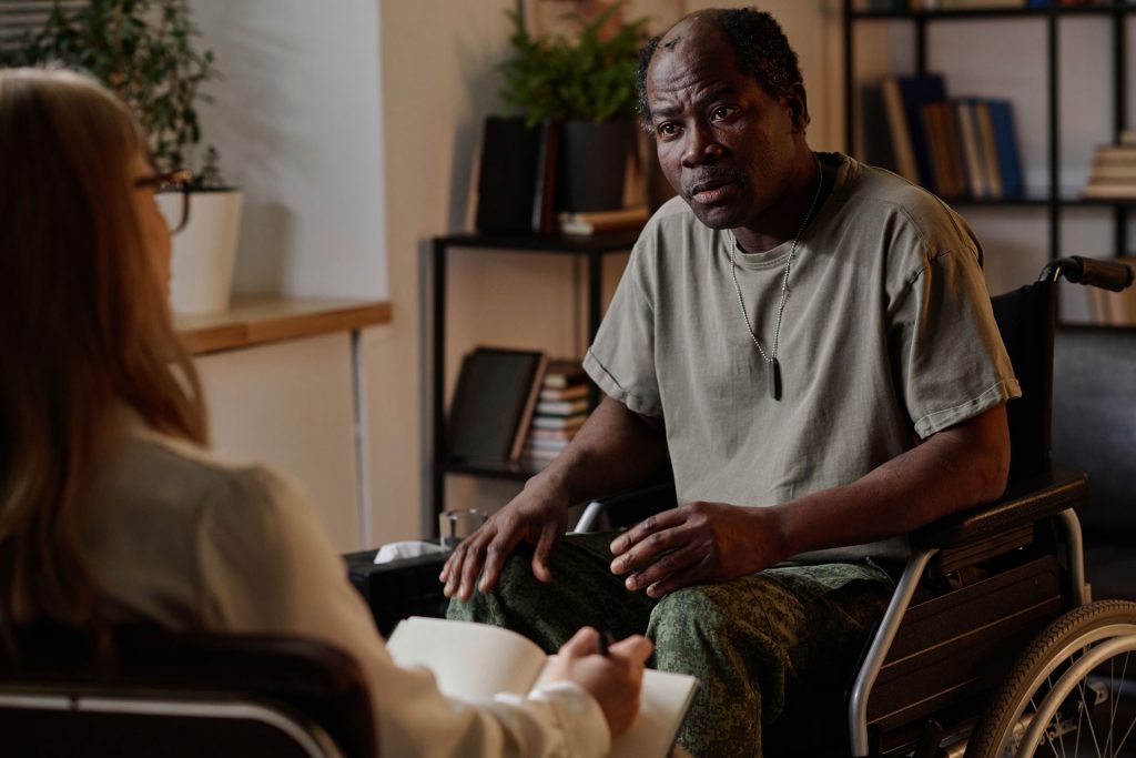 Mature in wheelchair with ptsd having a therapy.