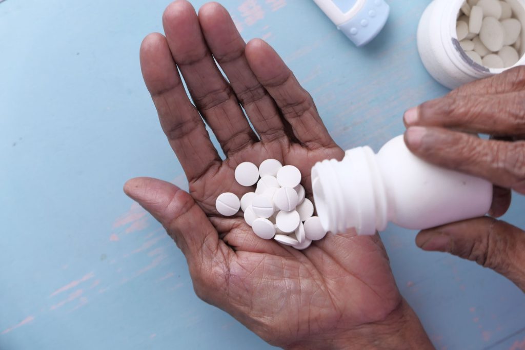 Hand of elder with suboxone.