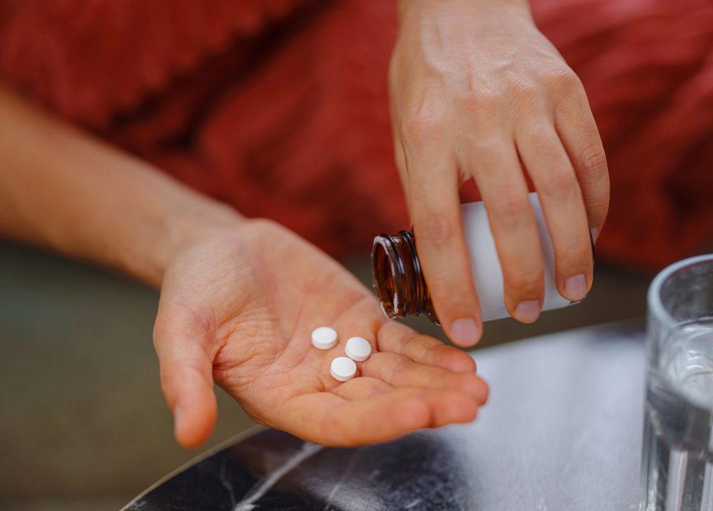 Person holding pills.