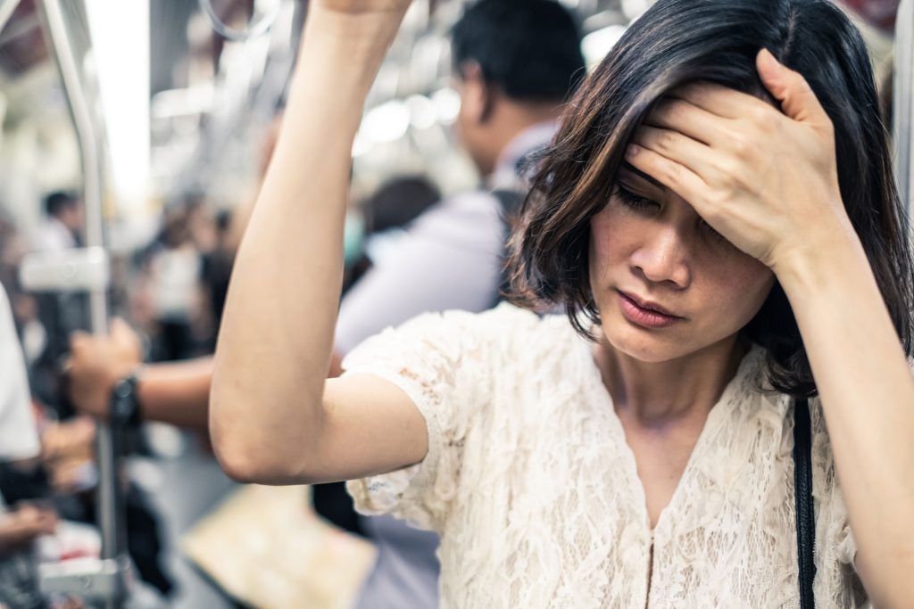 Woman stressed in train.