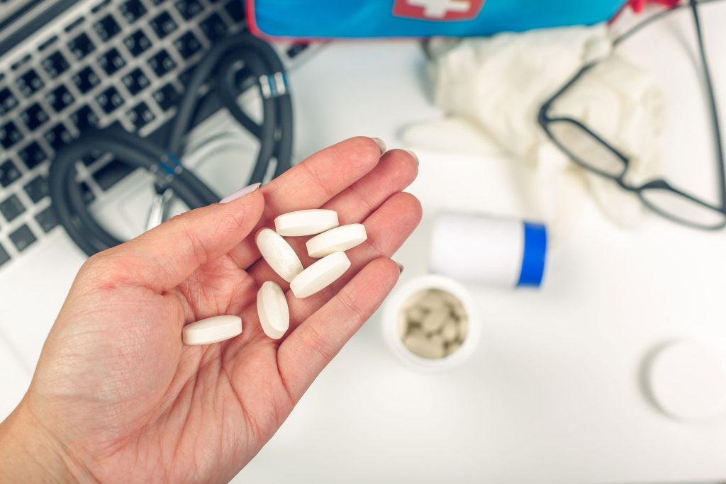 doctor holding pills on the table.