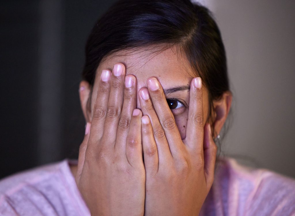 Woman covering her eye.