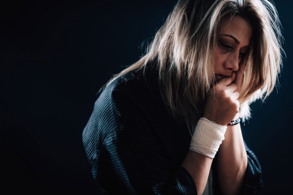 Woman with trauma looking depressed.