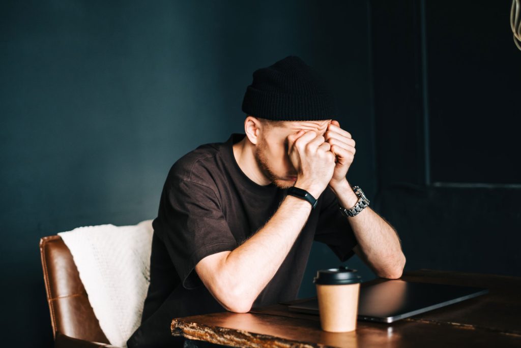 Man with major depression sitting.