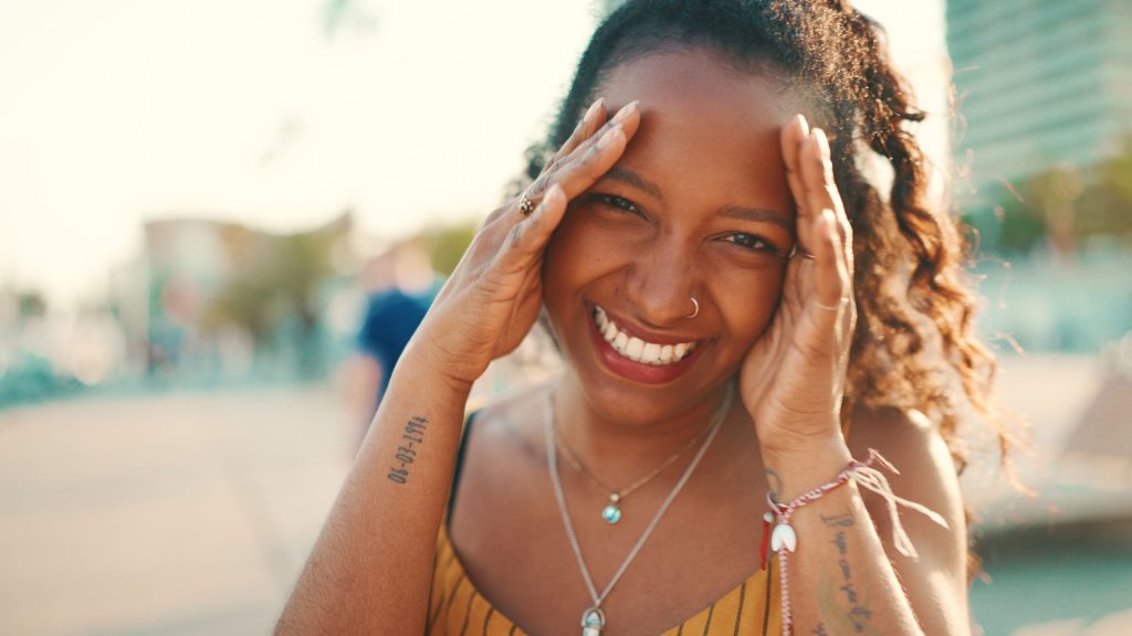 Woman with beautiful curly hair smiling.