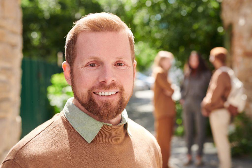 Smiling bearded man.