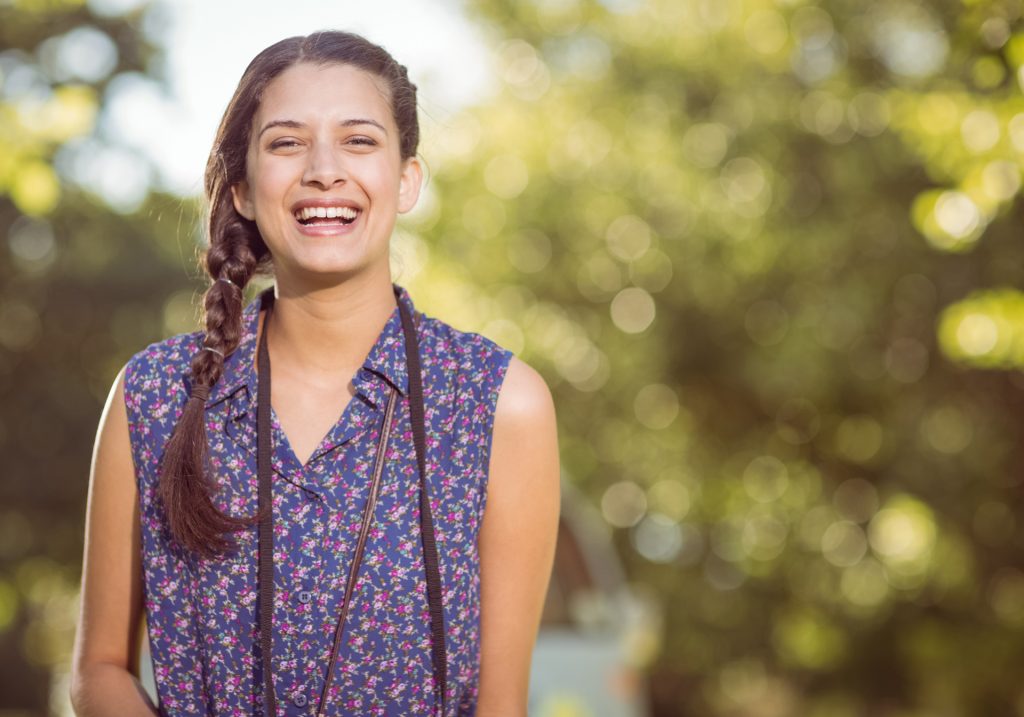 Pretty woman smiling at camera outdoors.